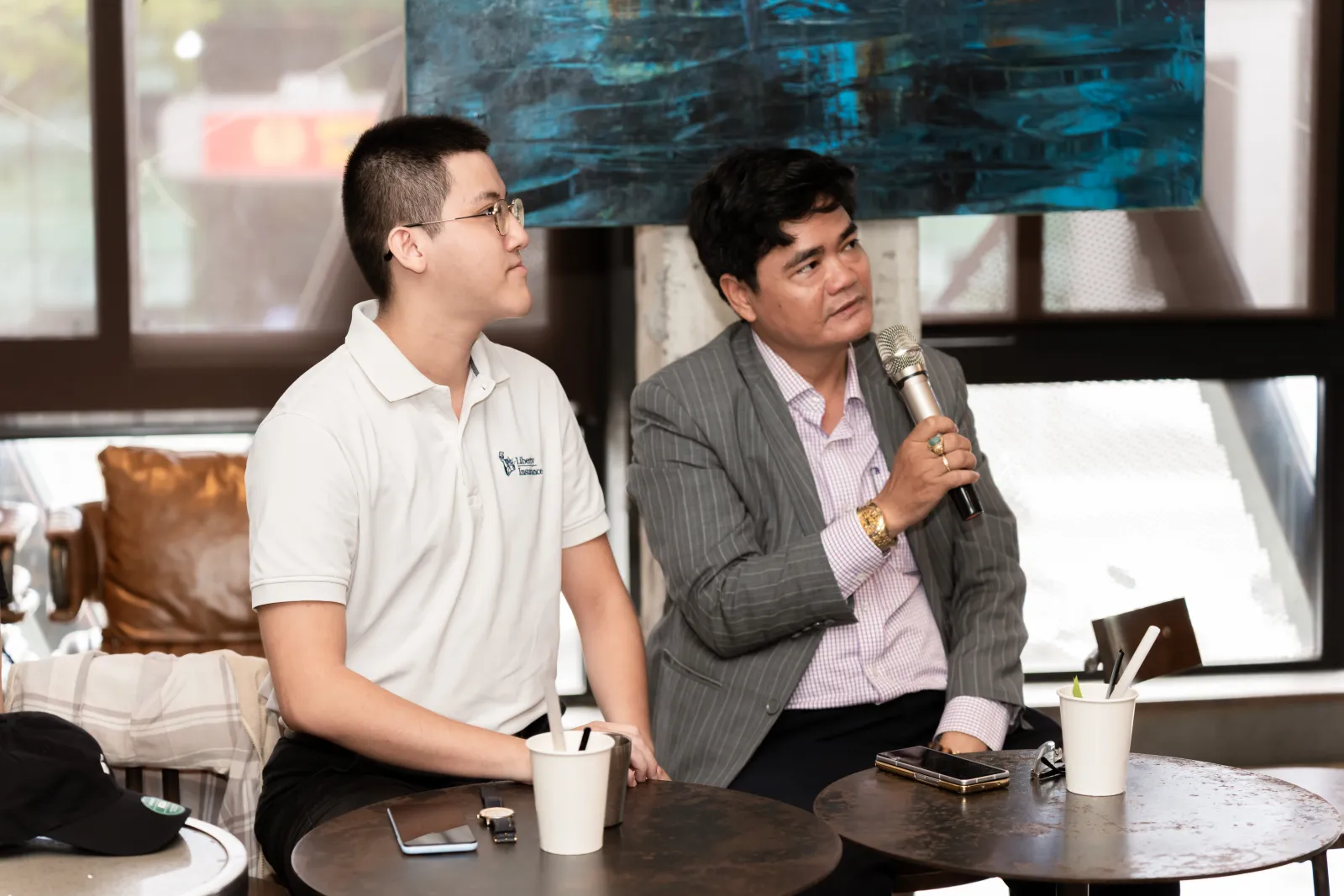 Hosts answering crowd questions during the Cafe Cursor Q&A