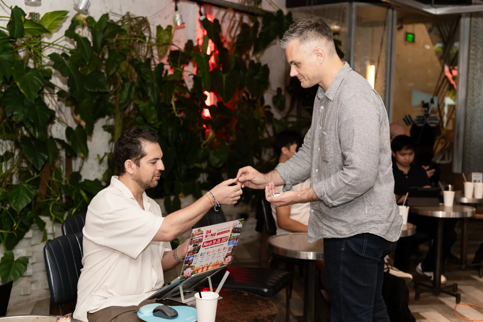 Joe Bellissimo handing out stickers during Cafe Cursor Da Nang