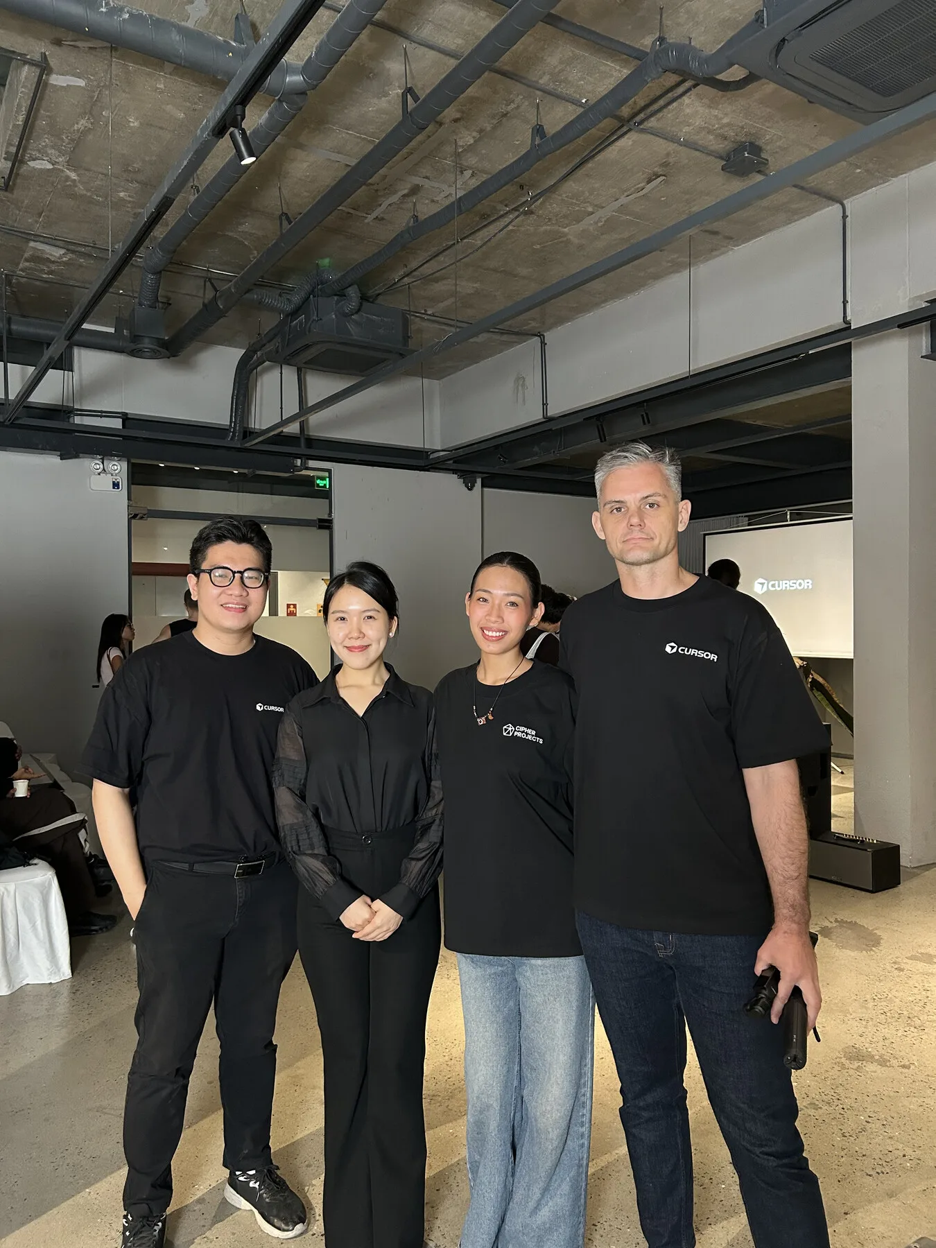 Nick Miller posing with attendees at The Local Beans in Da Nang